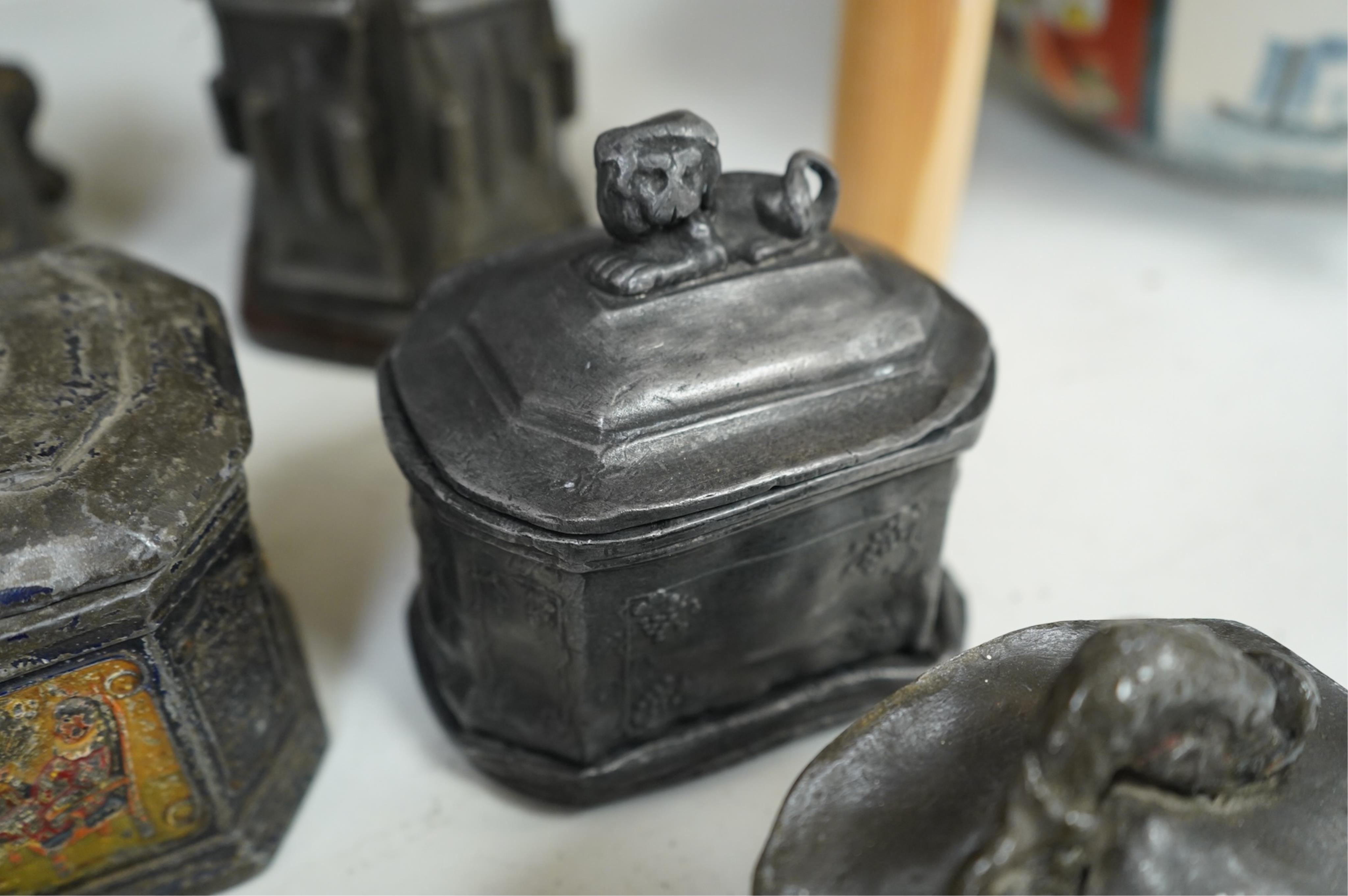 A collection of ten early 19th century lead tobacco boxes to include an octagonal example with remains of paintwork, largest 19cm high